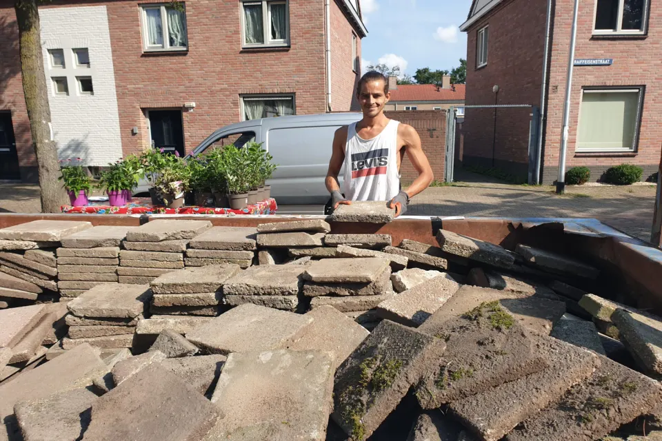 Grünfläche mit Bäumen an einem Wasserlauf in der Stadt